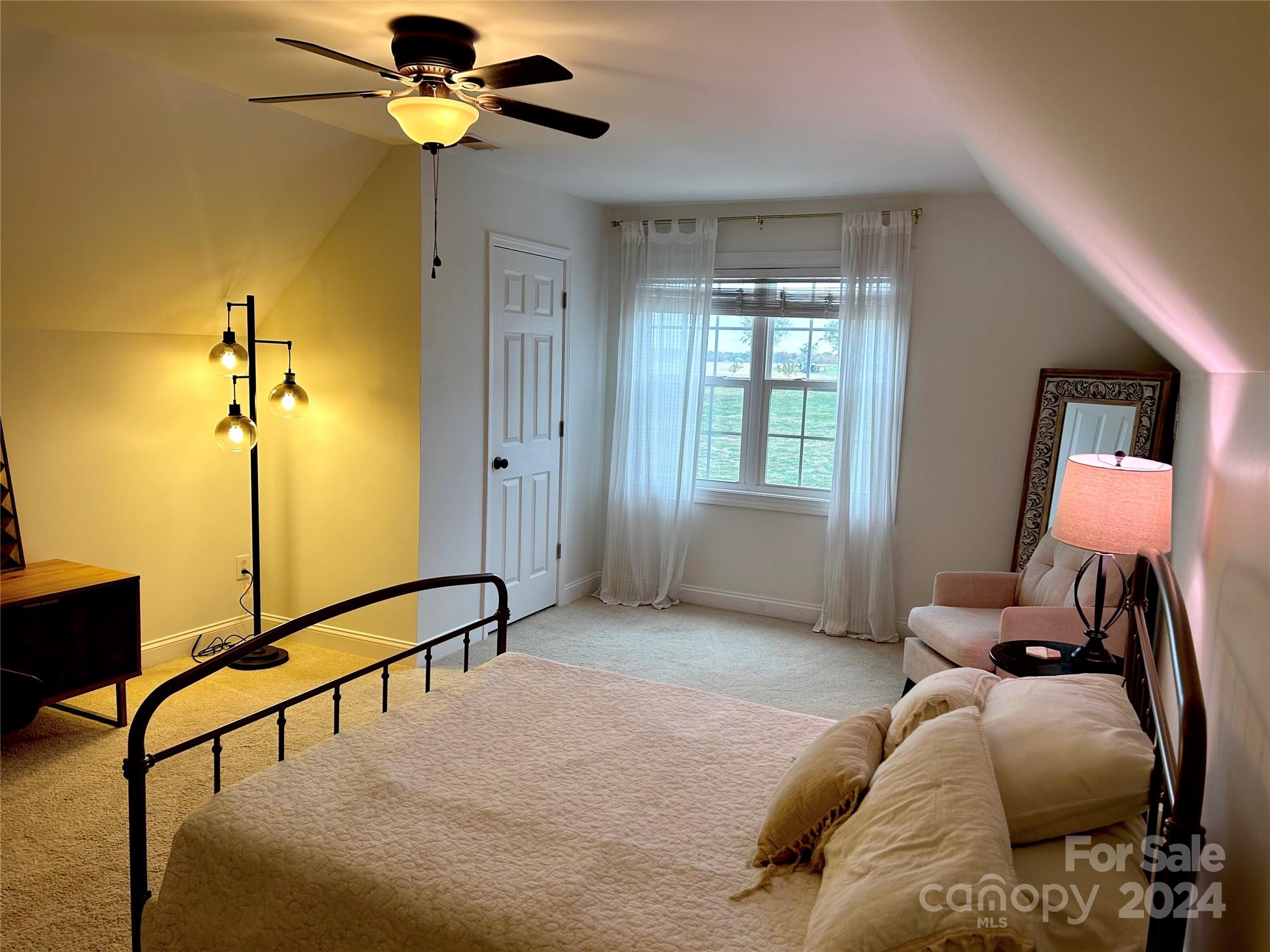 7400 Carl Polk Road Monroe, NC 28110 - Photo 32 of 48 a bedroom with a bed a dresser and the window