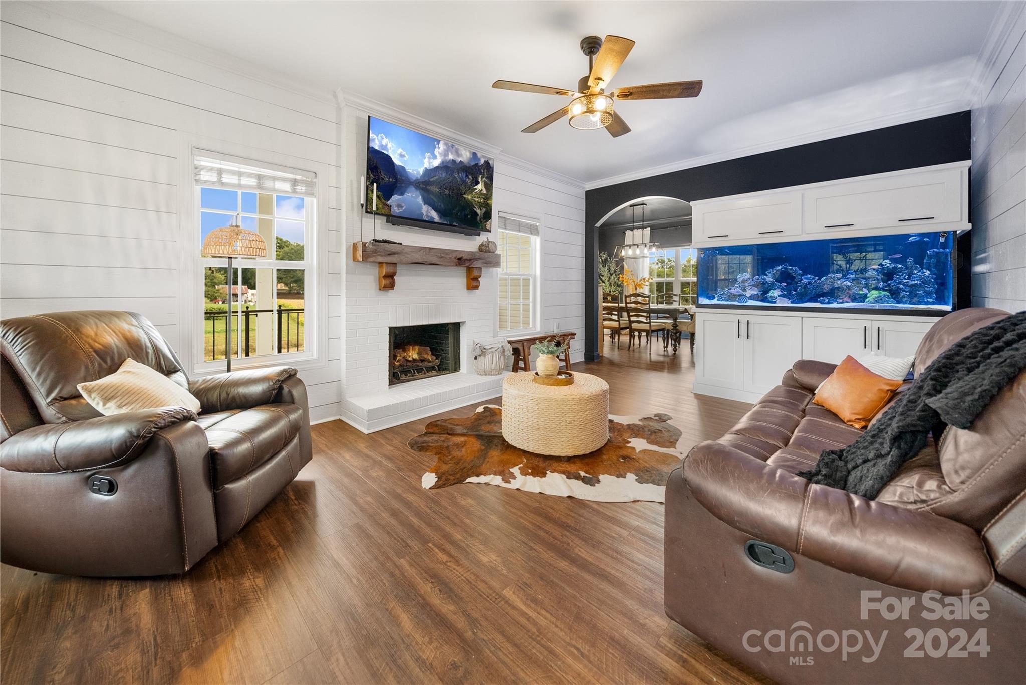 7400 Carl Polk Road Monroe, NC 28110 - Photo 4 of 48 a living room with furniture a fireplace and a flat screen tv
