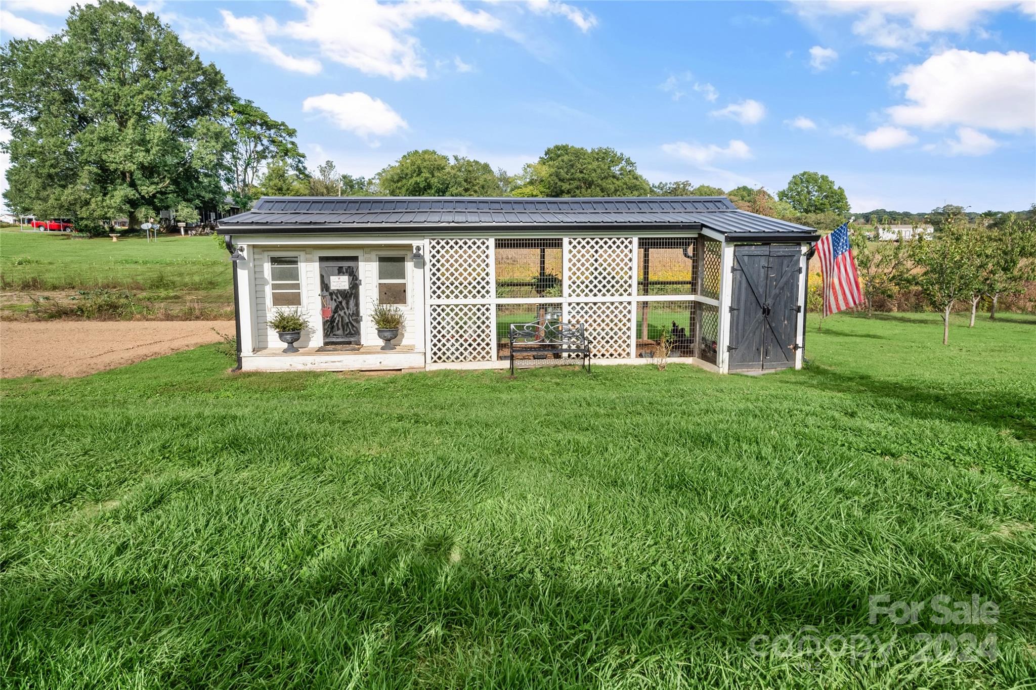 7400 Carl Polk Road Monroe, NC 28110 - Photo 43 of 48 a front view of a house with a yard table and chairs