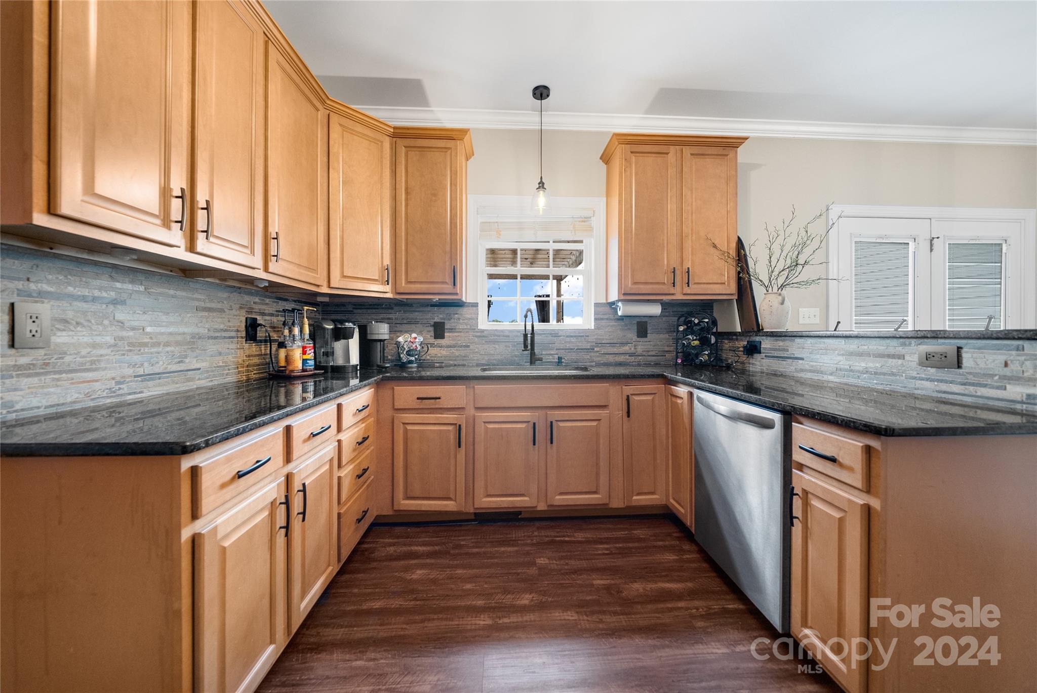 7400 Carl Polk Road Monroe, NC 28110 - Photo 9 of 48 a kitchen with granite countertop a sink and cabinets