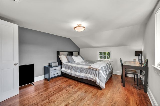 a bedroom with a bed and a desk