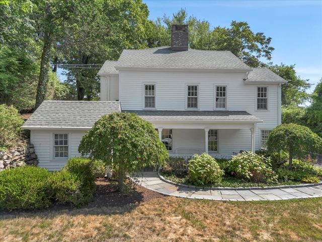 a aerial view of a house with yard and green space