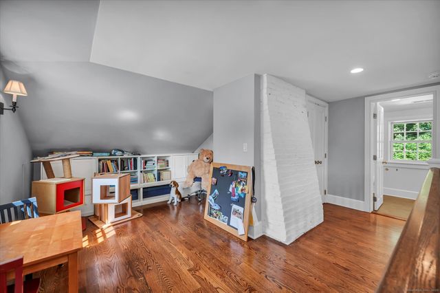 a living room with lots of furniture and wooden floors