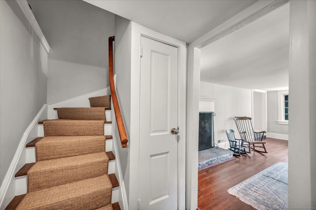 a view of entryway with wooden floor and dining room view
