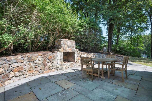 a roof deck with a table and chairs