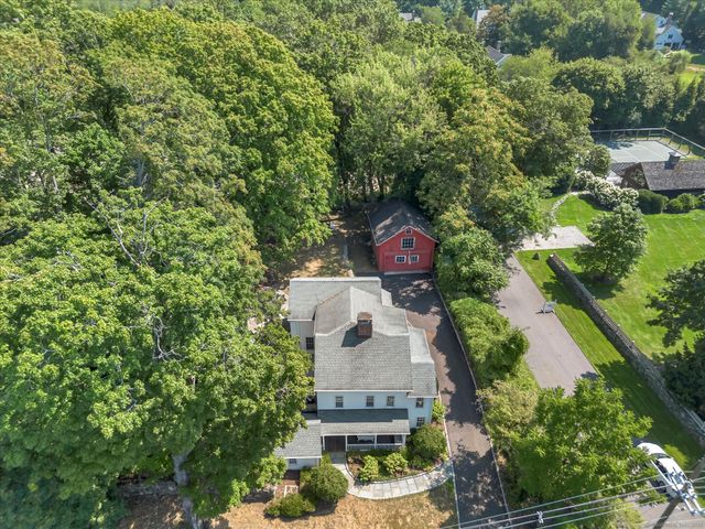 an aerial view of a house with yard and outdoor seating