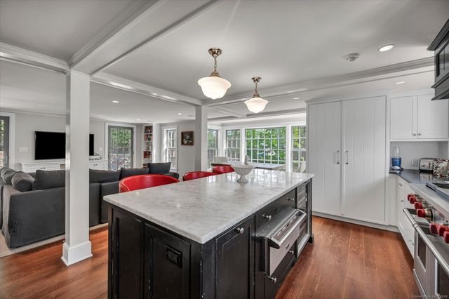 a view of kitchen island a sink and a refrigerator