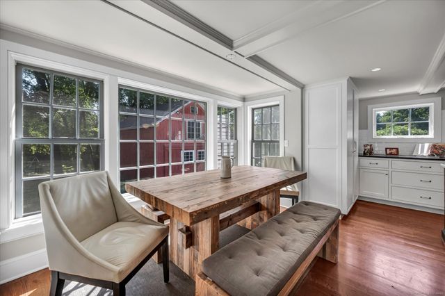 a view of a dining room with furniture window and wooden floor