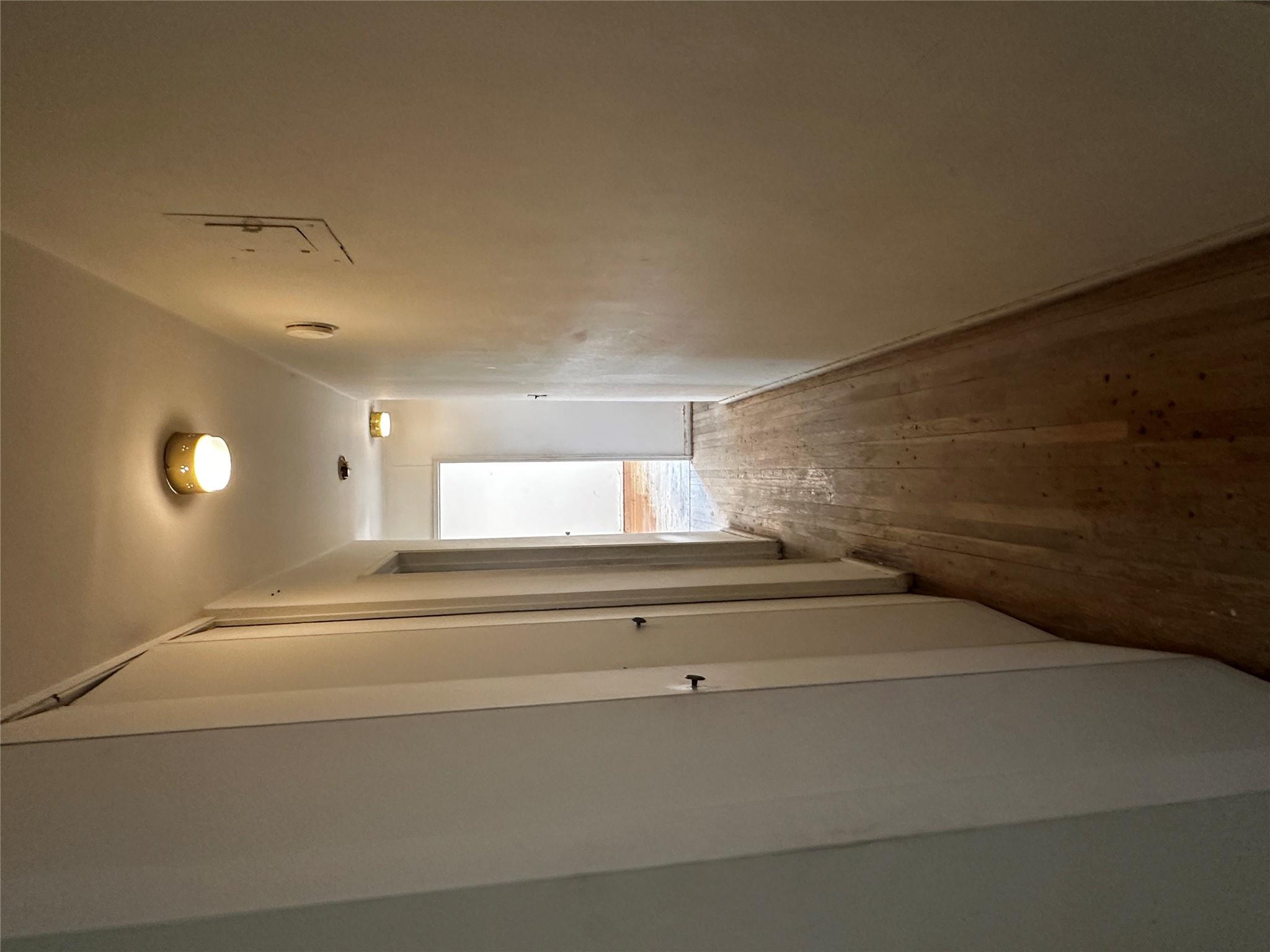 18-75 Corporal Kennedy Street, Unit 4A Queens, NY 11360 - Photo 11 of 25 Hallway featuring hardwood / wood-style floors