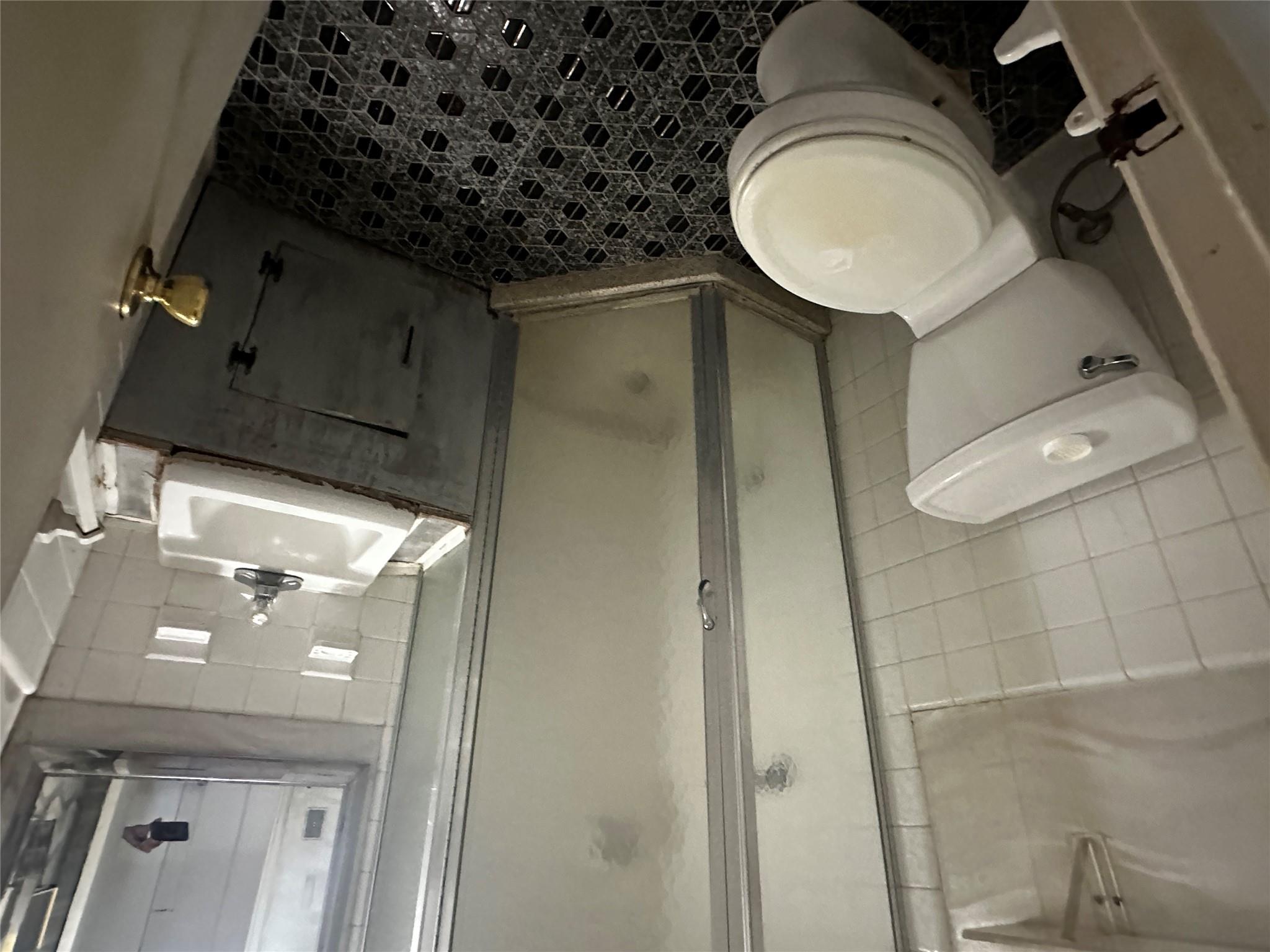 18-75 Corporal Kennedy Street, Unit 4A Queens, NY 11360 - Photo 15 of 25 Full bath with tile walls, vanity, and a stall shower