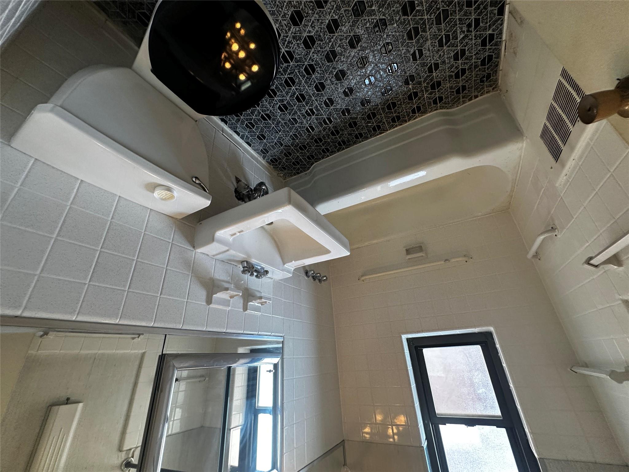 18-75 Corporal Kennedy Street, Unit 4A Queens, NY 11360 - Photo 17 of 25 Full bathroom with tile walls and shower / tub combination