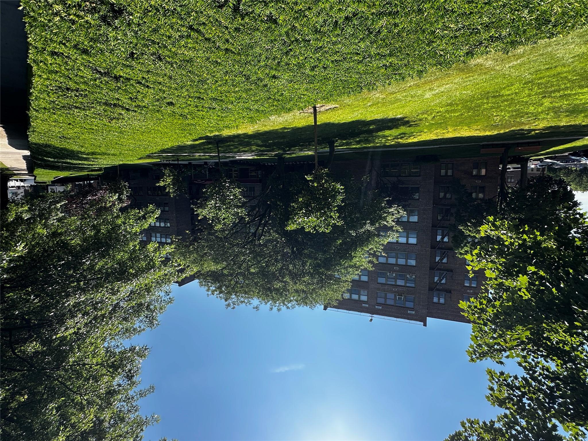 18-75 Corporal Kennedy Street, Unit 4A Queens, NY 11360 - Photo 2 of 25 View of property's community with a yard