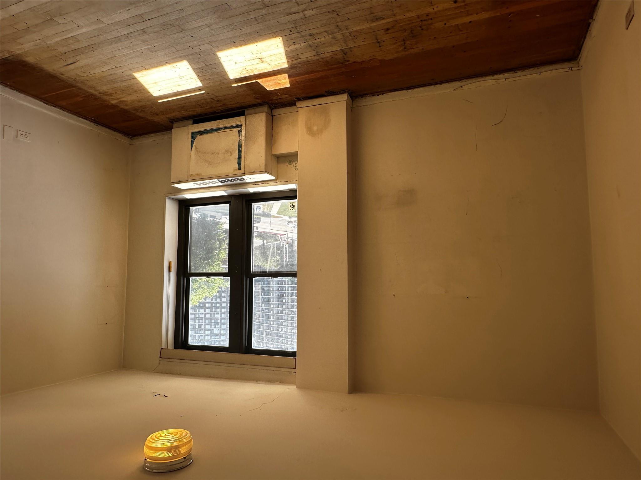 18-75 Corporal Kennedy Street, Unit 4A Queens, NY 11360 - Photo 22 of 25 Spare room featuring wood-type flooring and radiator