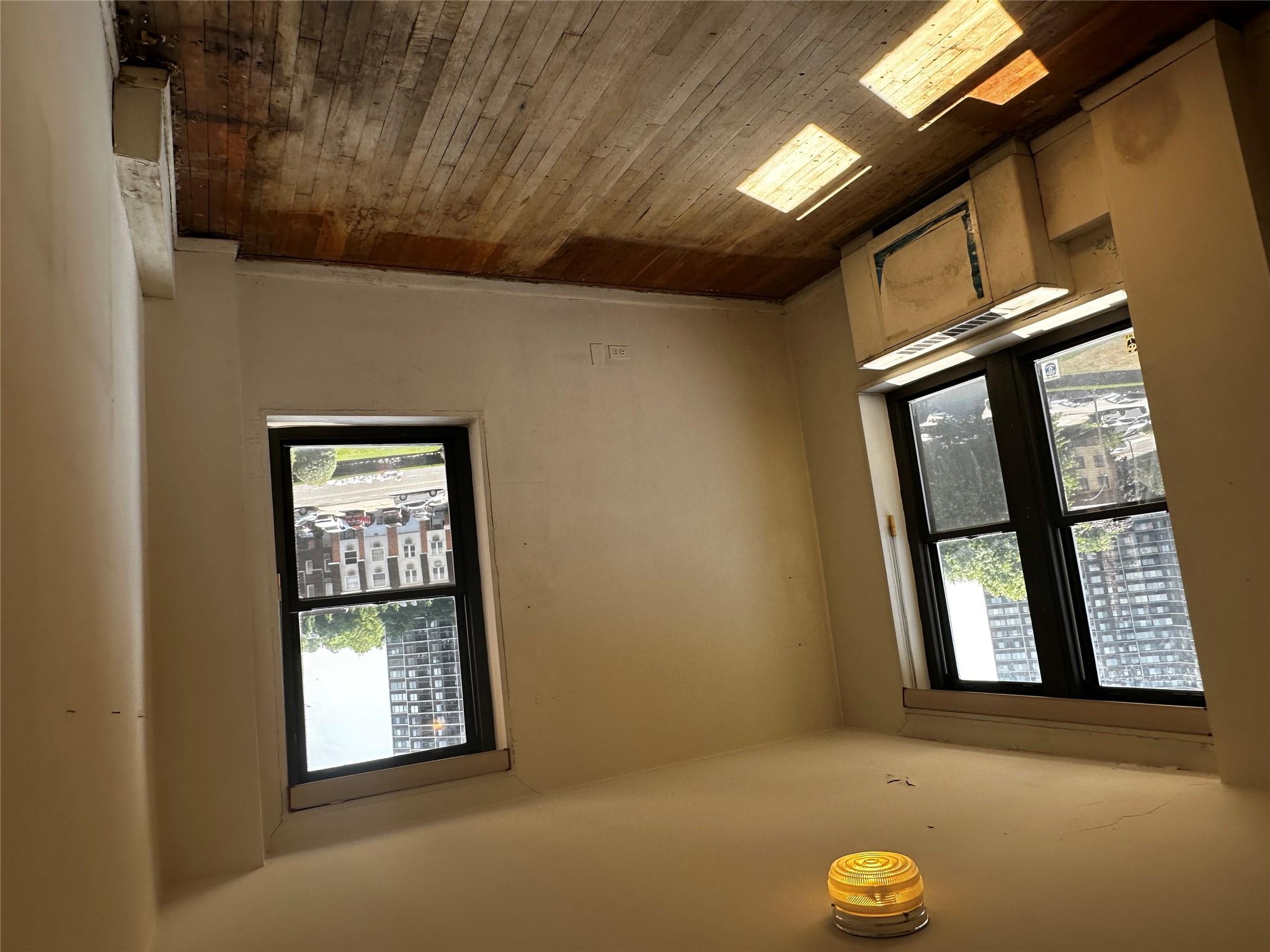 18-75 Corporal Kennedy Street, Unit 4A Queens, NY 11360 - Photo 23 of 25 Unfurnished room with hardwood / wood-style flooring and baseboards