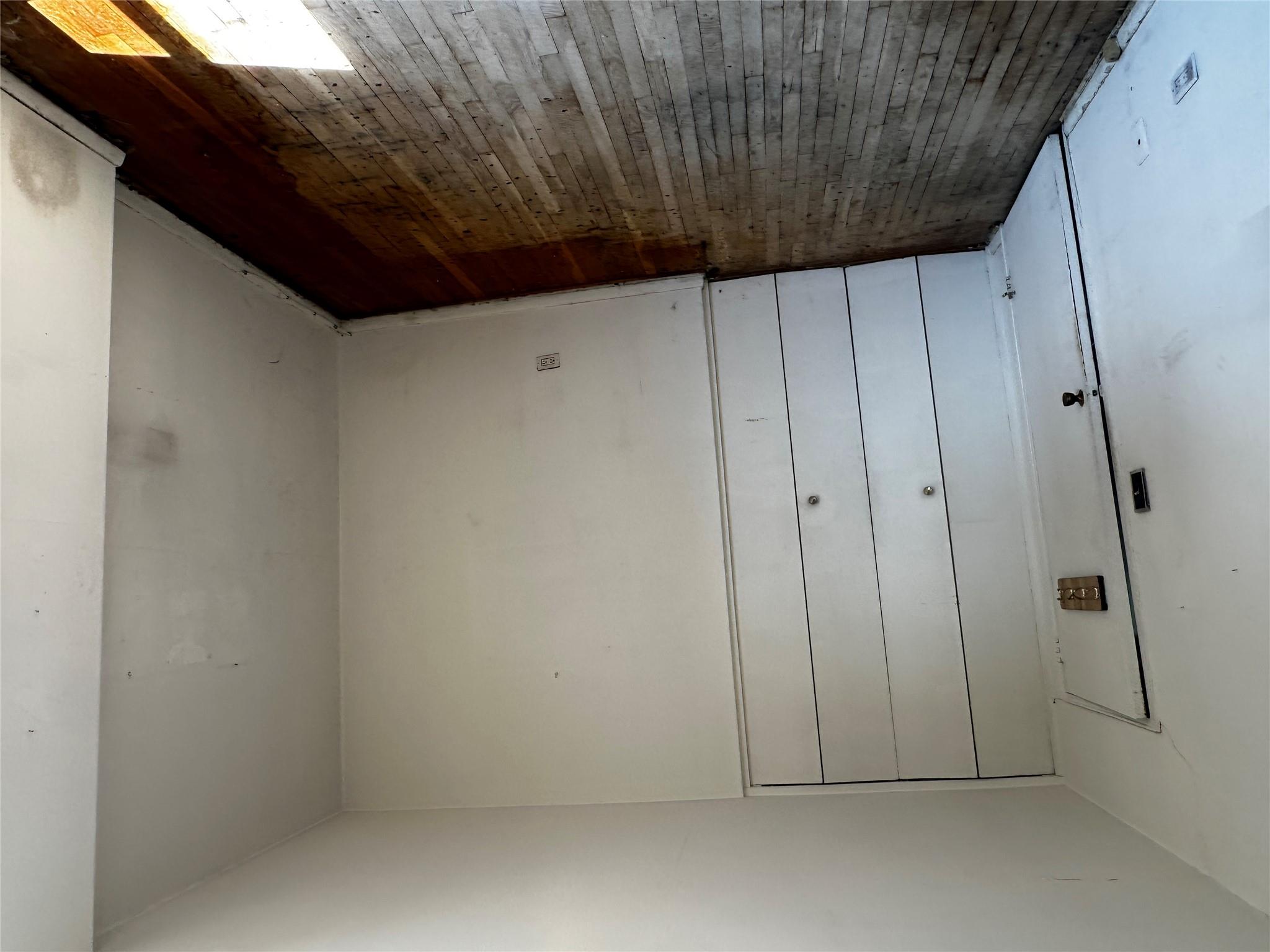 18-75 Corporal Kennedy Street, Unit 4A Queens, NY 11360 - Photo 24 of 25 Unfurnished bedroom with hardwood / wood-style floors and a closet