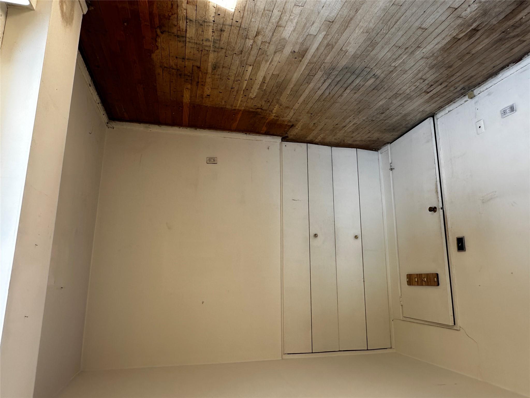 18-75 Corporal Kennedy Street, Unit 4A Queens, NY 11360 - Photo 25 of 25 Unfurnished bedroom featuring hardwood / wood-style flooring and a closet