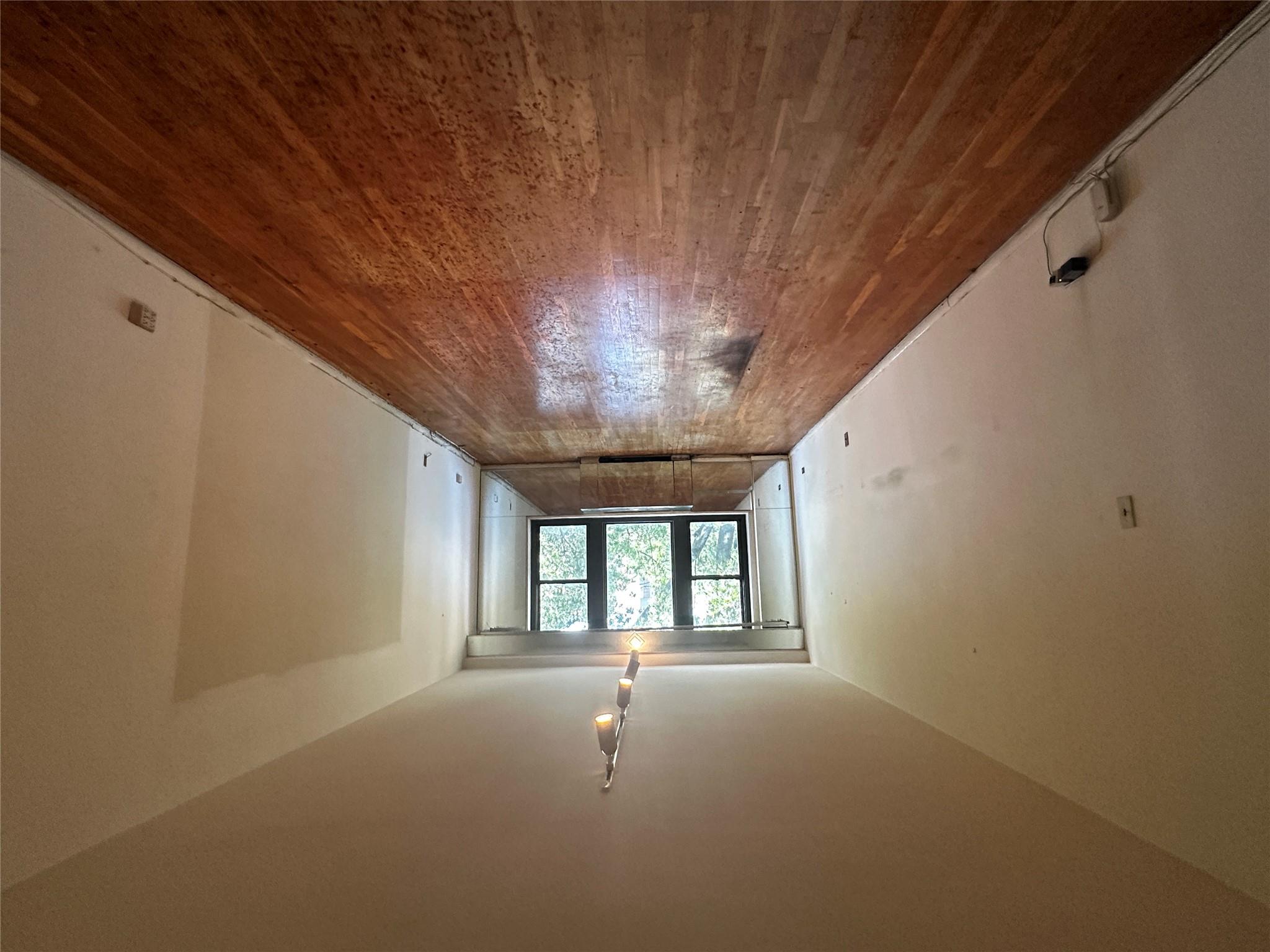 18-75 Corporal Kennedy Street, Unit 4A Queens, NY 11360 - Photo 5 of 25 Spare room featuring wood finished floors and track lighting
