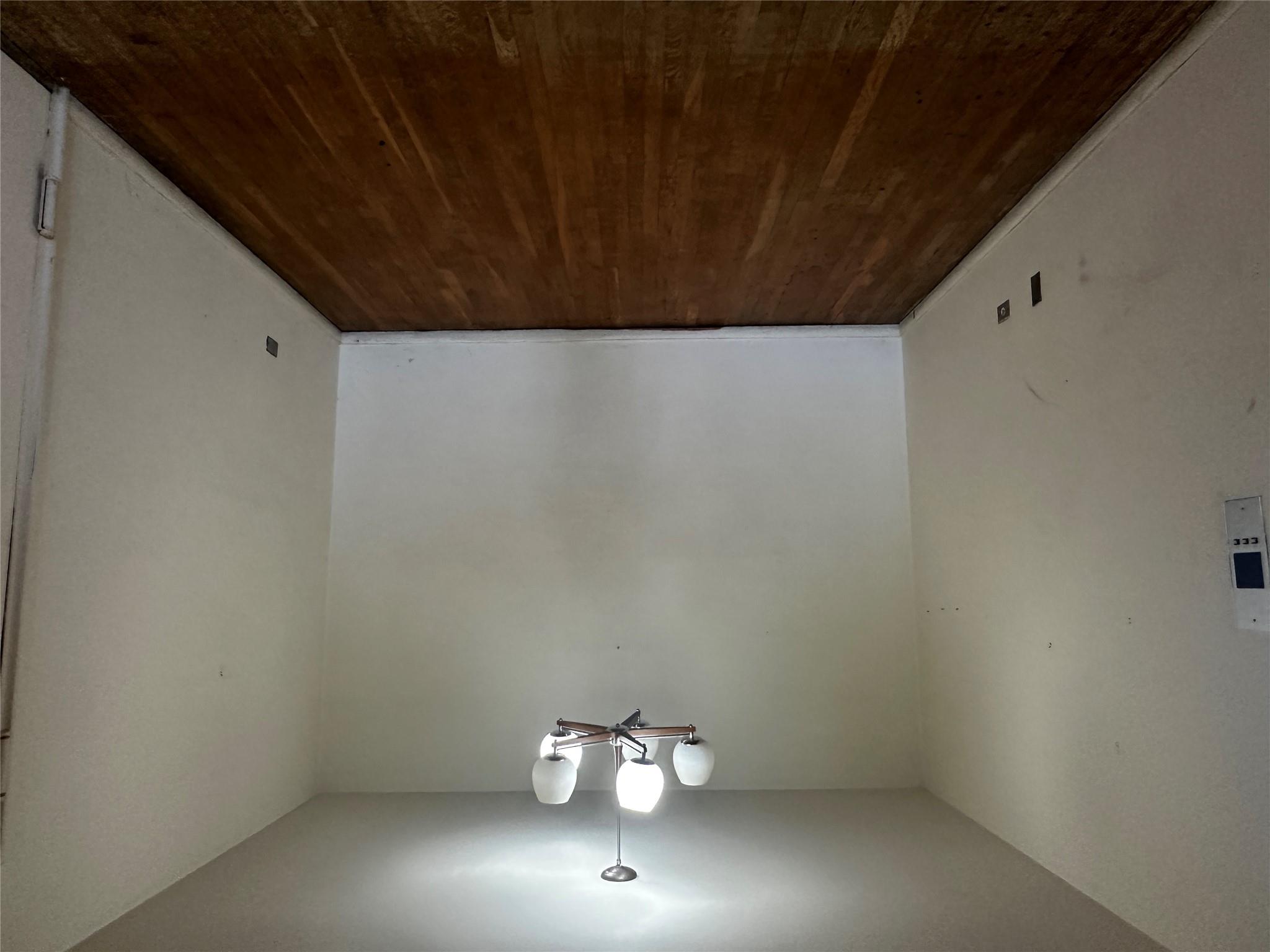 18-75 Corporal Kennedy Street, Unit 4A Queens, NY 11360 - Photo 7 of 25 Unfurnished room with wood finished floors and a chandelier