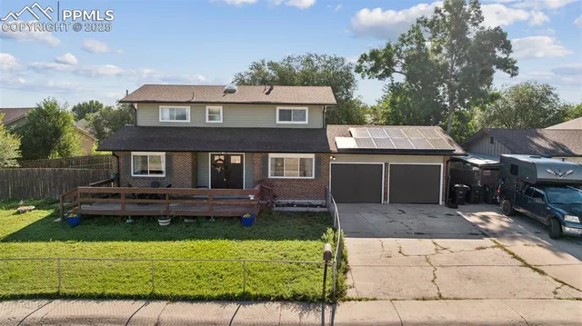 a front view of a house with a yard table and chairs