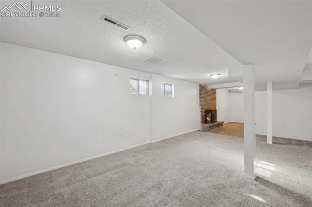 an empty room with a ceiling fan and windows