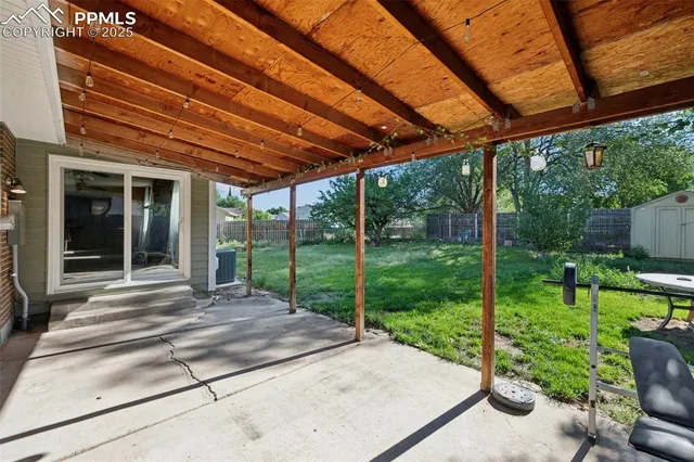 a view of a backyard with plants and a garden