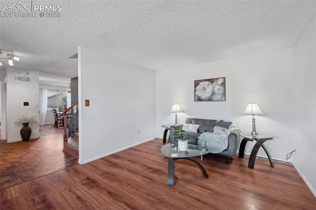 a workspace room with furniture and wooden floor