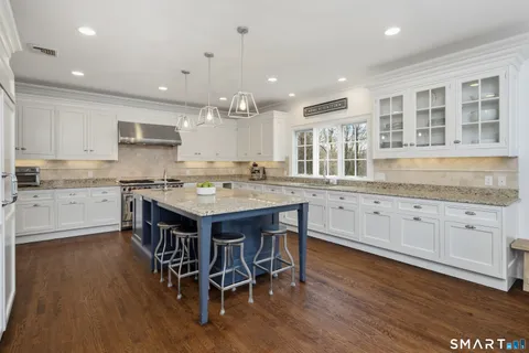 a kitchen with granite countertop a counter space stainless steel appliances and cabinets