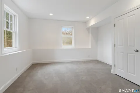 a view of a wooden door and a living room