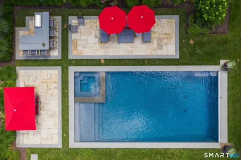 a patio with a table and chairs under an umbrella