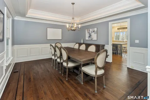 a view of a dining room with furniture wooden floor and chandelier