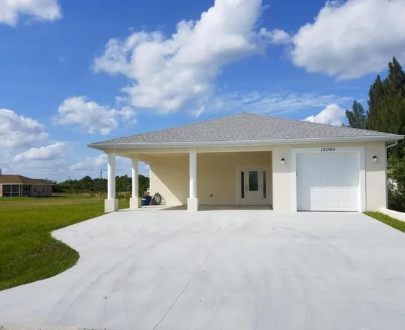 front view of a house with a big yard and a fountain