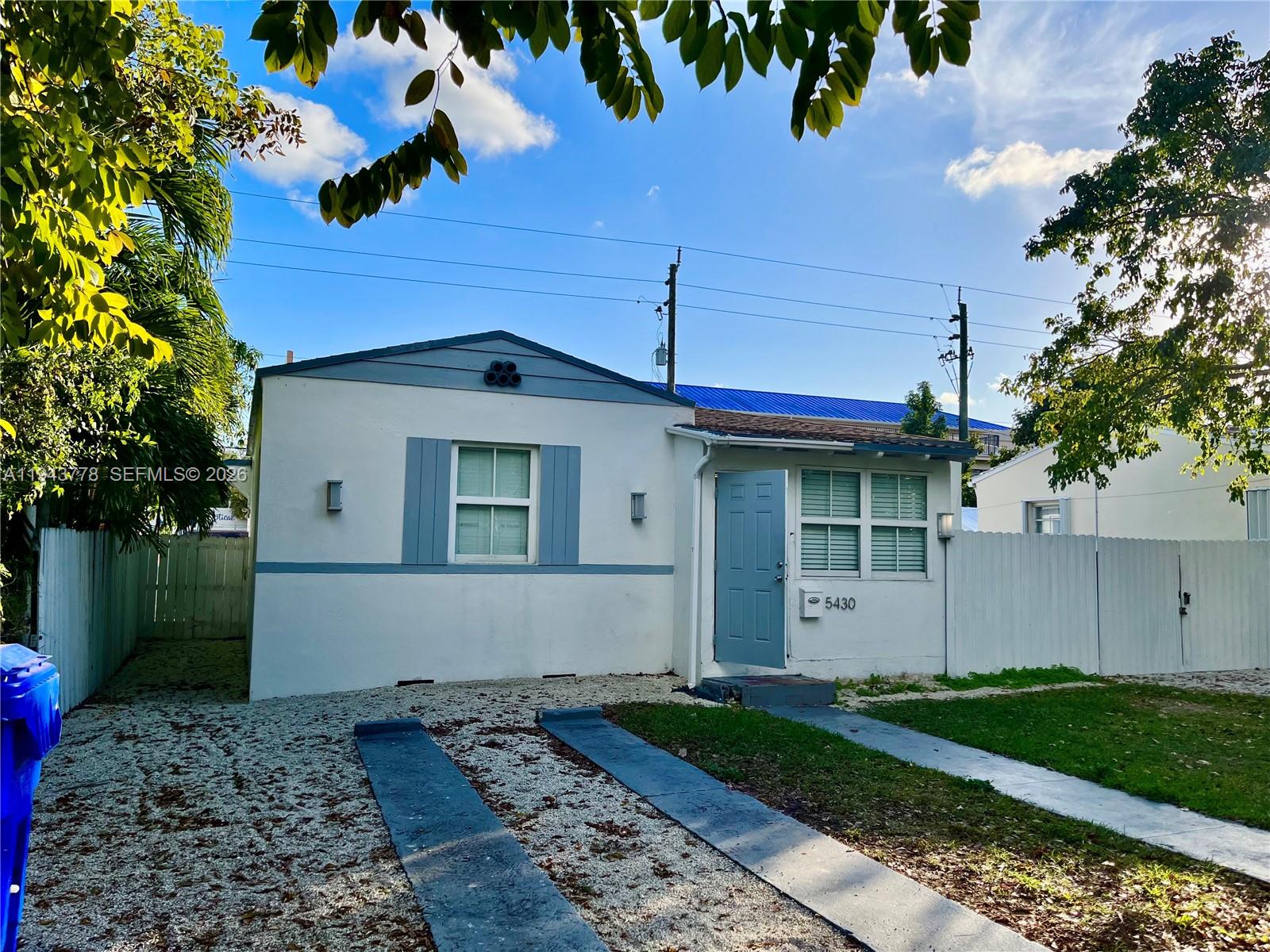 5430 Southwest 7th Street Miami, FL 33134 - Photo 2 of 16 a view of a house with a yard and a large tree