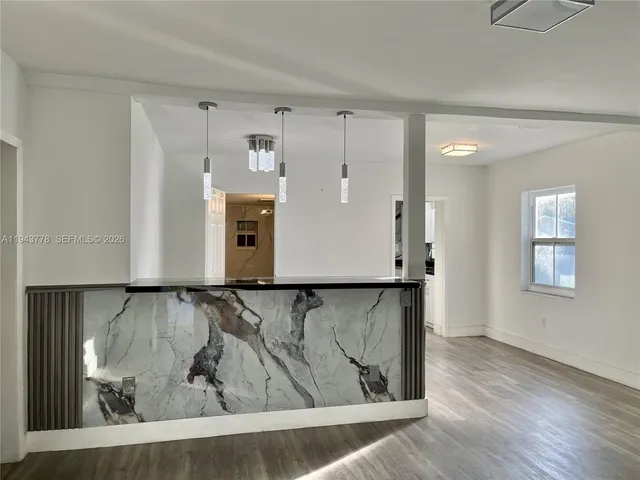 a view of a livingroom with wooden floor