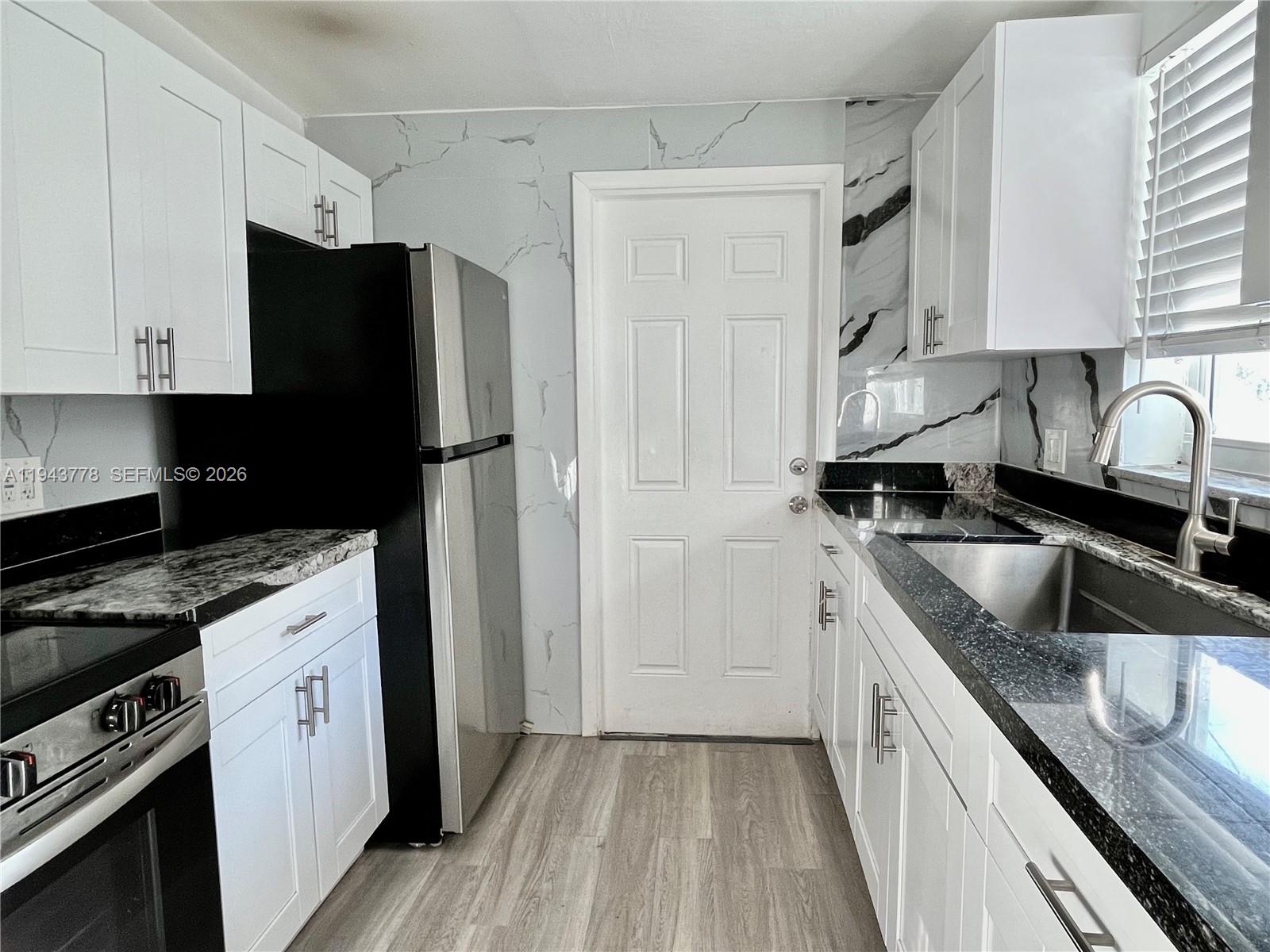 5430 Southwest 7th Street Miami, FL 33134 - Photo 6 of 16 a kitchen with a sink stove and refrigerator