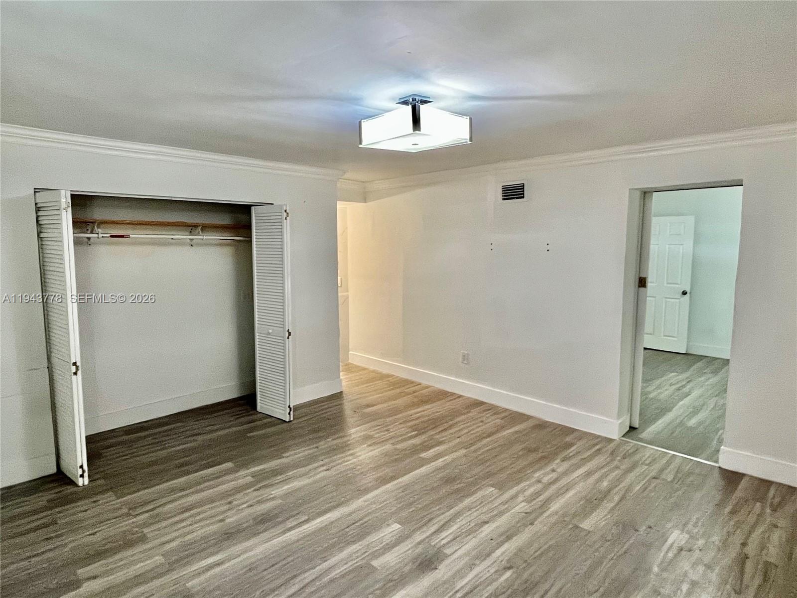 5430 Southwest 7th Street Miami, FL 33134 - Photo 8 of 16 an empty room with wooden floor and windows