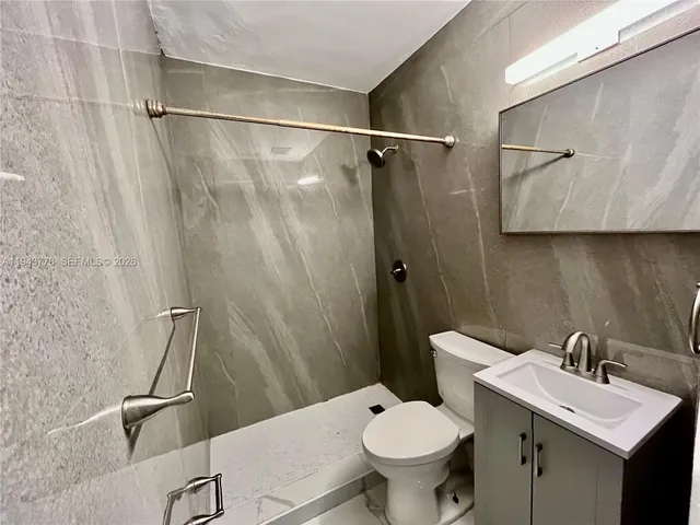 a bathroom with a sink toilet and shower