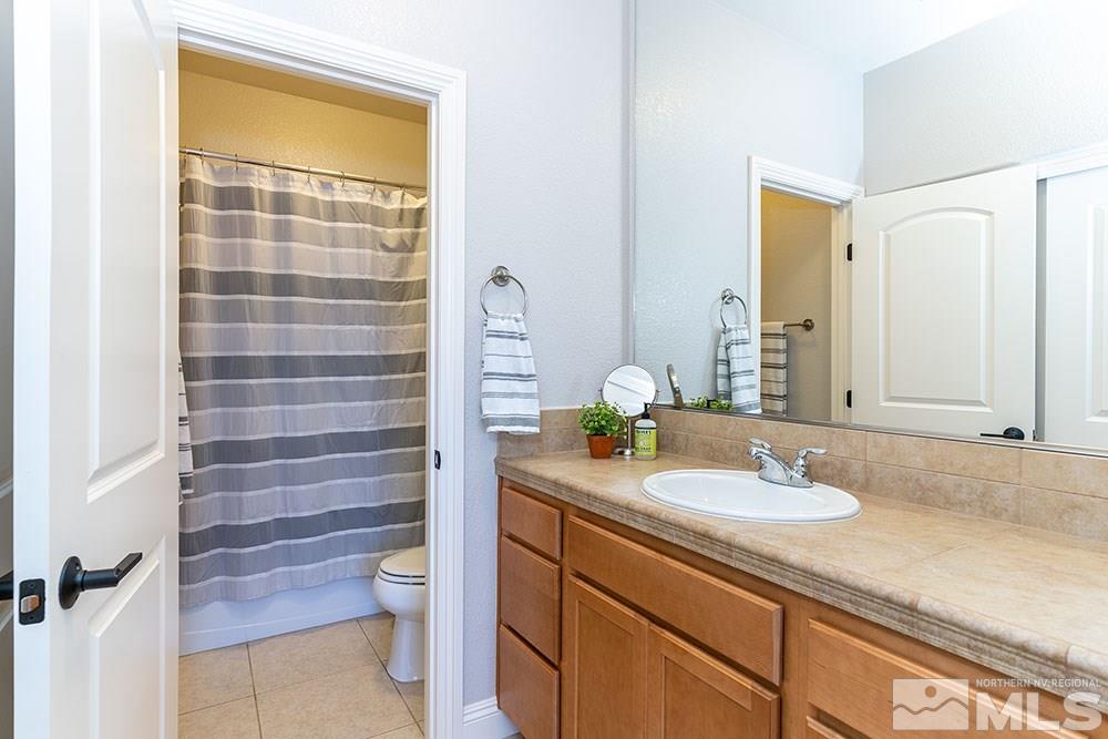 9825 Copenhagen Way Reno, NV 89521 - Photo 20 of 35 a bathroom with a granite countertop sink toilet and shower