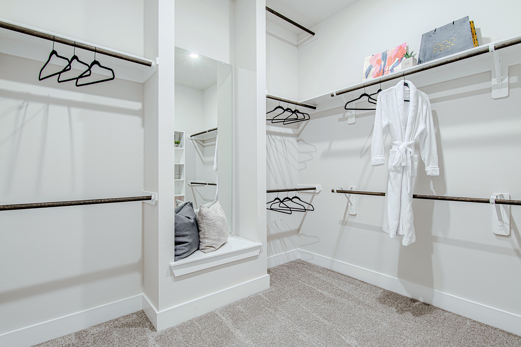 141 Peninsula Point Drive Montgomery, TX 77356 - Photo 25 of 47 This expansive walk-in closet boasts custom shelving, double rods, and even a built-in bench with mirror—style and storage in one.
