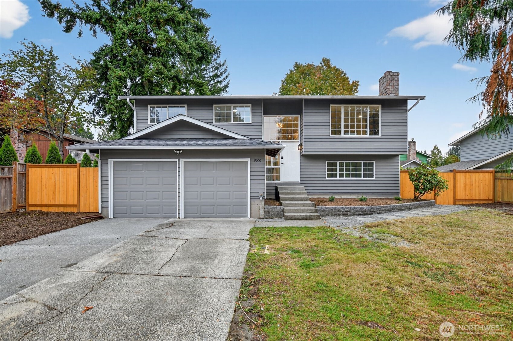 17203 Brook Boulevard Bothell, WA 98012 - Photo 1 of 31 a front view of a house with a yard and garage