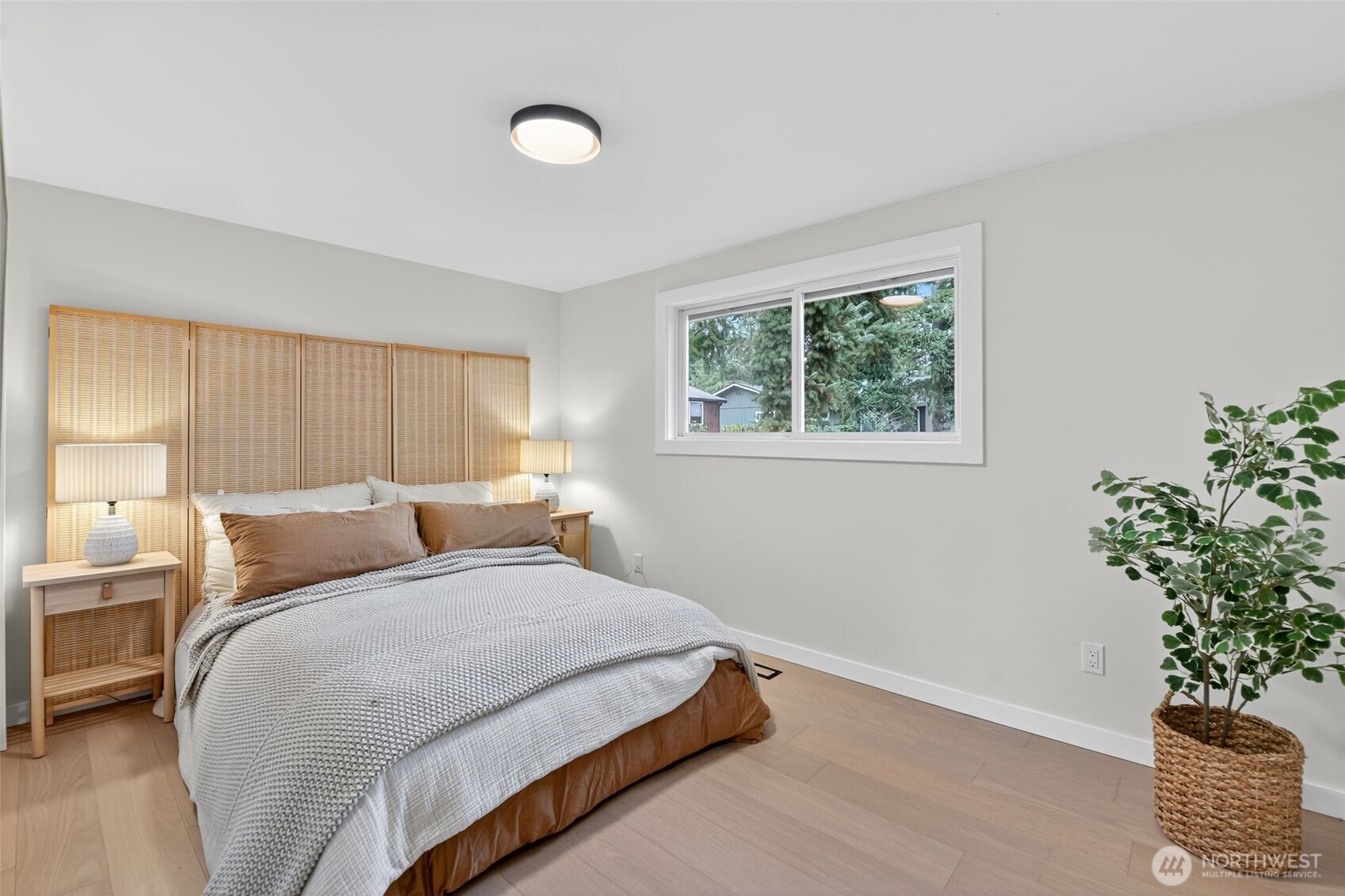 17203 Brook Boulevard Bothell, WA 98012 - Photo 11 of 31 a bedroom with a bed and a potted plant