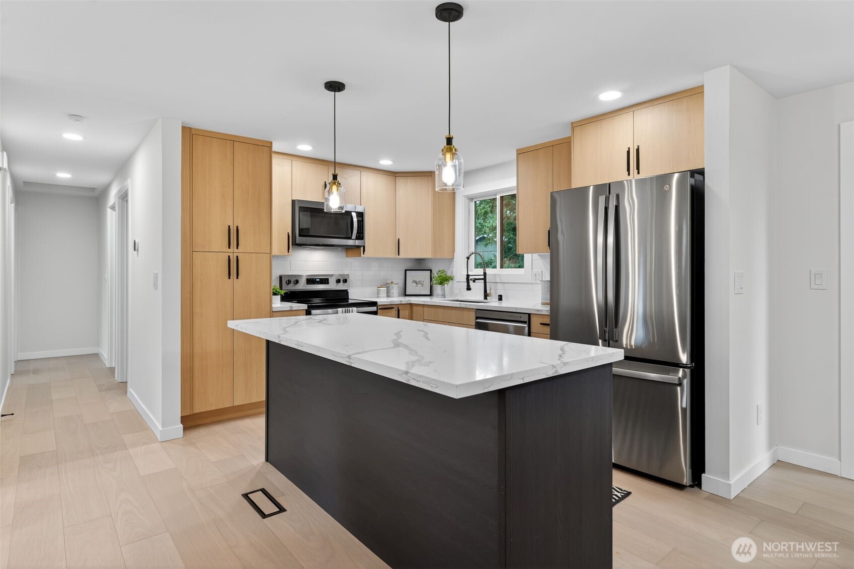 17203 Brook Boulevard Bothell, WA 98012 - Photo 5 of 31 a kitchen with stainless steel appliances granite countertop a refrigerator a sink a stove a microwave and a refrigerator