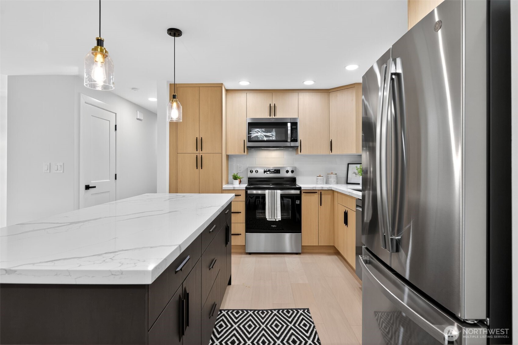 17203 Brook Boulevard Bothell, WA 98012 - Photo 6 of 31 a kitchen with stainless steel appliances a refrigerator sink and stove