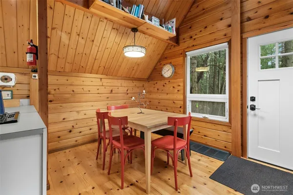 a patio with table and chairs and potted plants