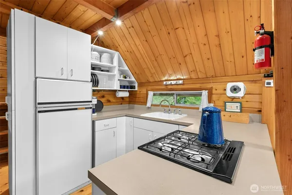 a kitchen with a refrigerator and a stove