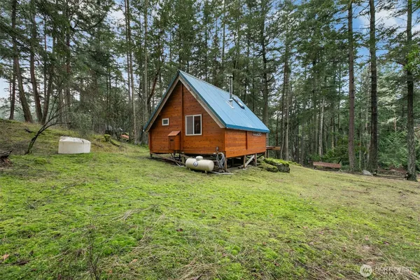 a view of a house with a yard and sitting area
