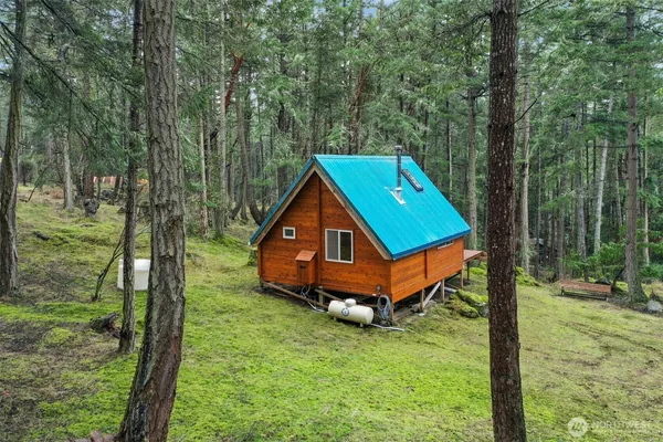 a backyard of a house with table and chairs
