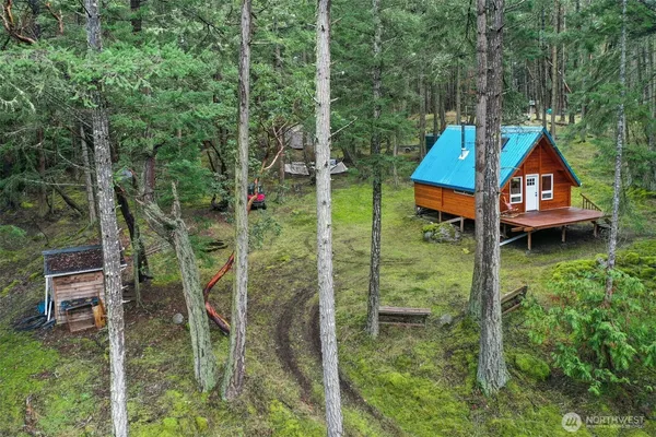 a aerial view of a house with a yard table and chairs