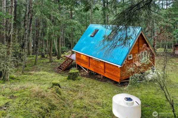 a backyard of a house with table and chairs