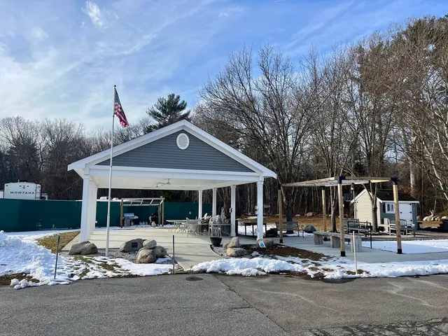 a front view of a house with cars parked