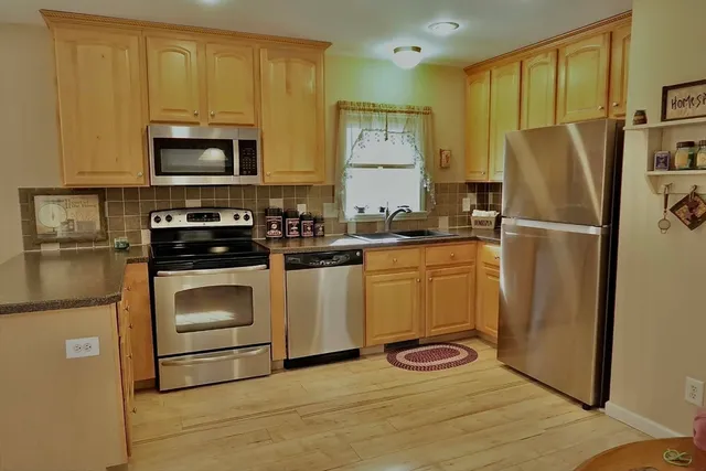 a kitchen with a refrigerator stove and microwave
